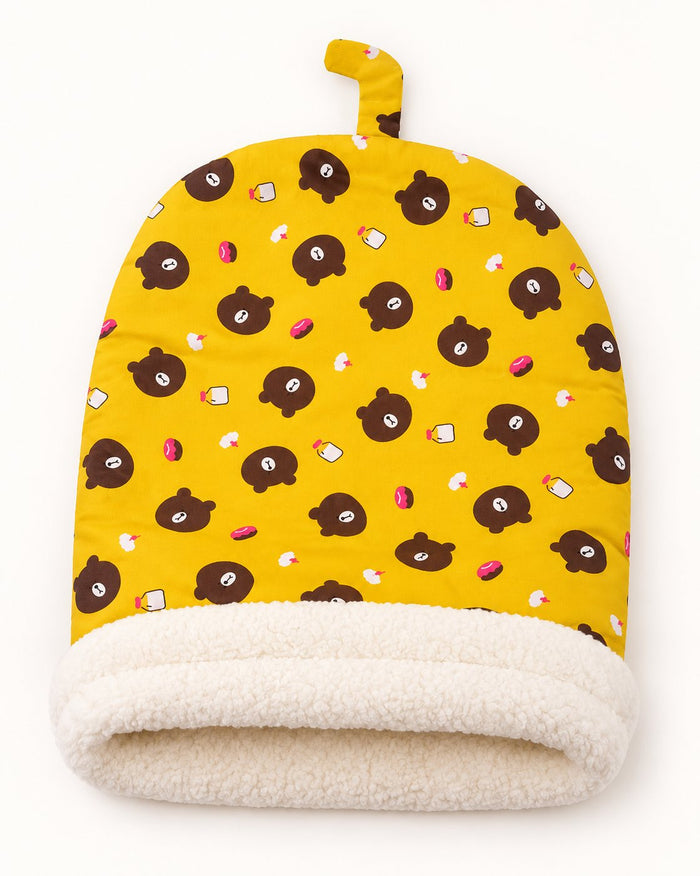 A Bear Yellow cat sleeping bag lying flat, with its small loop tab at the closed end
